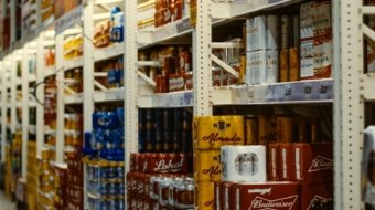 red and white labeled cans on shelf