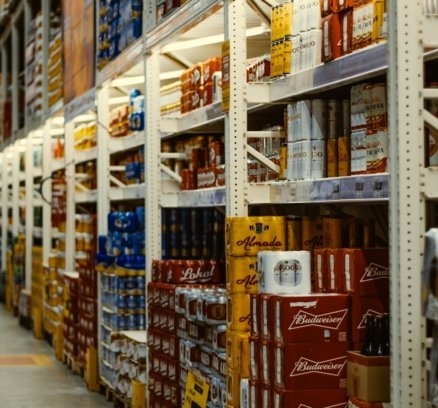 red and white labeled cans on shelf