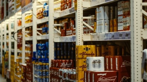 red and white labeled cans on shelf