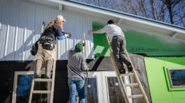 three person climbing on ladder