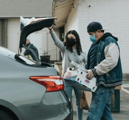 man in blue jacket standing beside woman in white jacket