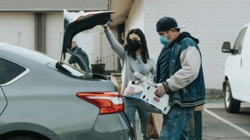 man in blue jacket standing beside woman in white jacket