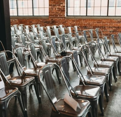 a room filled with lots of metal chairs